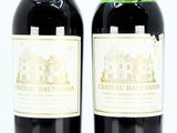 two bottles of wine sitting next to each other on a table