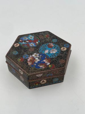 an image of a small black and blue box with flowers on it