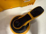 someone is using a rotary sander to clean the surface of the floor