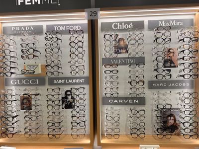 many pairs of glasses on display in a store window