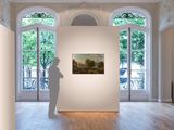 a sculpture of a man standing in front of a painting in a room