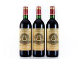 three bottles of wine sitting next to each other on a white surface