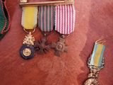 a small collection of medals and other items on a table