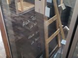 a glass door that has a sign on it in front of it