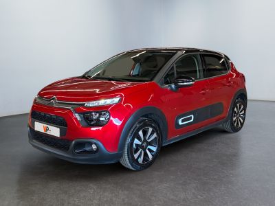 a red citrole is parked in a large room