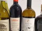 several bottles of wine are lined up on a white surface