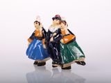 two figurines that are standing next to each other