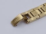 a gold bracelet with the word guess written on it