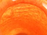 a close up of an orange that is in a bowl