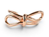 an image of a gold ring with a knot on it
