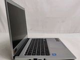 an open laptop computer sitting on top of a white surface