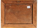 an old wooden picture frame with a tag on it