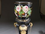 a vase on a stand with a chain around it