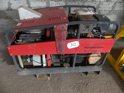a red and black machine sitting on a pallet