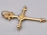 an image of a gold cross with a skull on it