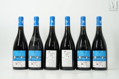 six bouteilles de vin sont alignées sur une table