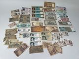 many different types of paper money laid out on a table