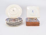 several plates and bowls sitting on top of each other on a white surface