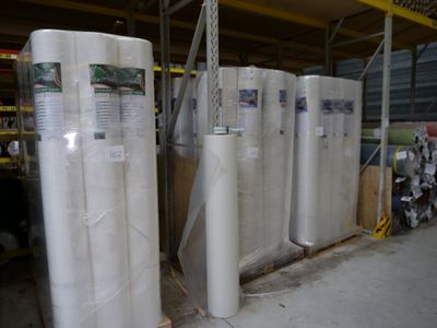 de nombreux rouleaux de matelas empilés dans un entrepôt