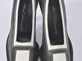 pair of black and white shoes on a white surface
