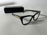 the glasses are black and have gold studding on the temples