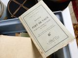 an old book sitting on top of a table next to a cup of coffee