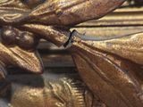 a close up view of a gold frame with a flower