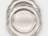 three silver plate on a white surface with a white background