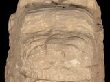 an image of a stone sculpture of a face on a black background