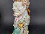 a figurine of a man with a book in his hand