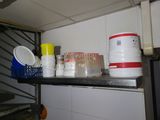 a shelf that has a lot of cups and containers on it