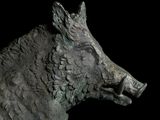 a statue of a boar that is standing in the dark