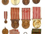 an assortment of medals and medals are displayed on a white surface