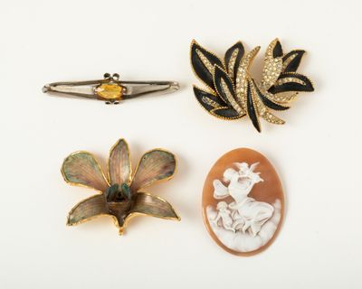 three brooches of various shapes and sizes on a white surface