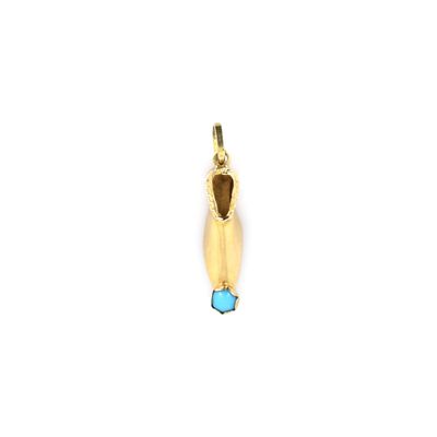 a close up of a gold pendant with a blue stone