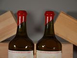 two bottles of wine sitting next to each other on a table