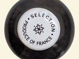 a close up of a black and white ball with a white label