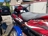 a red and black jet ski parked in a driveway