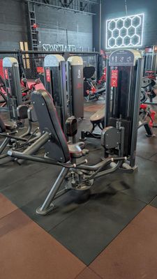 a gym with a lot of machines in the room