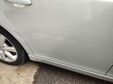 a car that has been washed with water on the side of the road