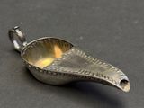 a silver spoon that is on a black surface