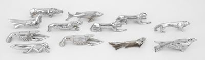 a lot of silver metal animals on a white surface