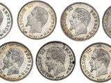 a group of six different british coins on a white background