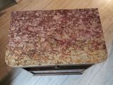 a small table with a marble top on a wooden floor