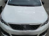 a picture of a white car parked in a parking lot