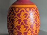 two vases sitting next to each other on a table