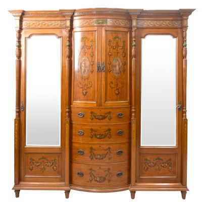 a large wooden armoire with a mirror on top of it