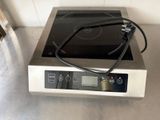 une photo d'une plaque de cuisson sur laquelle se trouve un brûleur noir