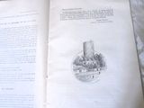 a book open on a bed with a picture of a castle in the background