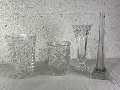 three glass vases and a candle holder on a table